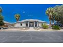 Inviting single-story home featuring desert landscaping, mature trees, and a welcoming entrance at 1420 Logandale Dr, Logandale, NV 89021