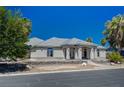 Attractive single-story home with desert landscaping and mature palm trees in front yard at 1420 Logandale Dr, Logandale, NV 89021