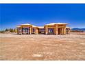 New construction home with a bright blue sky, wooden framing and black windows at 1550 W Jornada St, Pahrump, NV 89048