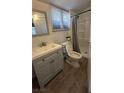Bathroom featuring a shower, modern vanity, and a toilet next to a window at 1844 Yale St, North Las Vegas, NV 89030