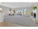 Bright living room features neutral carpet, fireplace, and large windows with mountain views at 2110 Fort Sanders St, Henderson, NV 89052