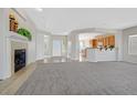 Spacious living room boasts neutral carpet, fireplace, and open layout at 2110 Fort Sanders St, Henderson, NV 89052