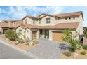 Inviting two-story home with a landscaped front yard and a modern garage door at 212 Harris Peak St, Las Vegas, NV 89138