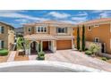 Charming two-story home featuring a tile roof, porte-cochere, and manicured landscaping at 2154 Tortona St, Henderson, NV 89044