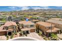 Desirable home featuring a tile roof, porte-cochere, and meticulously maintained landscaping at 2154 Tortona St, Henderson, NV 89044