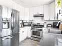 Modern kitchen with stainless steel appliances, white cabinetry, and a neutral countertop at 2337 Sierra Sunrise St, Las Vegas, NV 89156