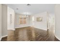 An expansive open room features hardwood floors, arched doorways and lots of natural light at 258 Chamomile Dr, Henderson, NV 89015