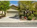 Charming home featuring mature trees, manicured bushes, and a spacious two-car garage at 3048 Scalise Ct, Las Vegas, NV 89141