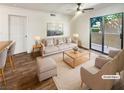Bright, staged living room featuring a ceiling fan, neutral furniture, and access to a patio at 3135 S Mojave Rd # 152, Las Vegas, NV 89121