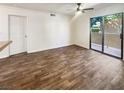 Empty living room with a ceiling fan, wood-look floors, and a sliding glass door to the outside at 3135 S Mojave Rd # 152, Las Vegas, NV 89121