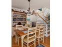 Traditional dining room features a classic table set and hutch adjacent to staircase at 3233 Southridge Ave, Las Vegas, NV 89121