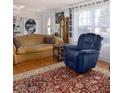 Cozy living room showcases a comfortable sofa, recliner, and decorative rug on hardwood floors at 3233 Southridge Ave, Las Vegas, NV 89121