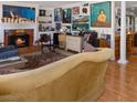 Cozy living room with a fireplace, hardwood floors, and an eclectic collection of art on the walls at 3233 Southridge Ave, Las Vegas, NV 89121