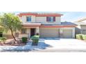 Inviting home with a well-maintained lawn, porch, and three-car garage at 3309 Green Ice Ave, North Las Vegas, NV 89081