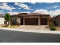 Charming single-story home featuring a brick-accented facade, desert landscaping, and a spacious two-car garage at 3395 Sleeping Hills Ave, Henderson, NV 89044