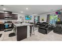 Open-concept living room with a seamless flow to the kitchen, perfect for modern living and entertaining at 3517 Arcadian King Ave, Las Vegas, NV 89106