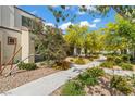 Picturesque street view showcasing lush landscaping with walking path and a community of stylish homes at 3517 Arcadian King Ave, Las Vegas, NV 89106