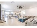 Spacious living room and kitchen area with modern ceiling fan at 4145 Nopal Serrano Ave, Las Vegas, NV 89141