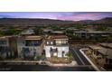 Overhead view of modern home in a suburban neighborhood surrounded by desert landscape and mountains at 4153 Solace St, Las Vegas, NV 89135