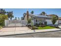Attractive single-story home with metal security gates, a manicured lawn, and a two-car garage at 4302 Newhaven Dr, Las Vegas, NV 89147