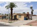 A quaint home with an expansive driveway and a distinctive brick chimney for added charm at 513 Berry Cir, Las Vegas, NV 89107