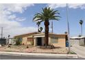 Inviting single-story home with a decorative palm tree and desert landscaping at 513 Berry Cir, Las Vegas, NV 89107
