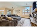 Bright living room features vaulted ceilings, large sectional sofa, and fireplace at 5638 Wild Olive St, Las Vegas, NV 89118