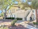 Charming two-story condo with lush landscaping and a convenient stairway access at 5710 E Tropicana Ave # 1055, Las Vegas, NV 89122