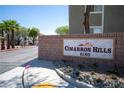 Cimarron Hills community entrance with lush landscaping, a stone sign, and palm trees at 6160 Rumrill St # 121, Las Vegas, NV 89113