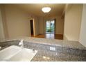 Granite-topped bar overlooking bright living area, perfect for entertaining at 62 E Serene Ave # 129, Las Vegas, NV 89123