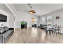Spacious living room featuring hardwood floors, ceiling fan, and ample natural light at 6829 Painted Morning Ave, Las Vegas, NV 89142