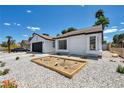 Attractive single-story home with low-water rock landscaping and a neatly arranged succulent garden at 6939 Paddington Way, Las Vegas, NV 89147