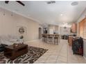 Open living area with kitchen, bar seating, and access to a dining space at 7697 Morning Lake Dr, Las Vegas, NV 89131