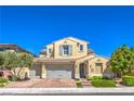 Charming two-story home with a three-car garage, beautiful landscaping, and brick paved driveway at 8126 Majestic Bighorn St, Las Vegas, NV 89166