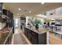 Open kitchen featuring an island with granite countertops and stainless steel appliances at 8126 Majestic Bighorn St, Las Vegas, NV 89166