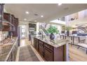 Open-concept kitchen featuring a granite island, modern appliances, and an inviting breakfast bar at 8126 Majestic Bighorn St, Las Vegas, NV 89166