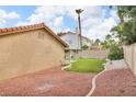 Large backyard space featuring low-maintenance landscaping, a stucco wall, and a covered patio at 8316 Vibrant Dr, Las Vegas, NV 89117