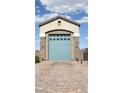 Spacious single car garage with stone accents and a charming arched entrance at 8528 Baltimore Heights Ct, Las Vegas, NV 89113