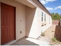 Front exterior featuring a red door with a well kept landscaped entrance at 9526 Borough Park St, Las Vegas, NV 89178