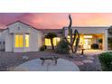Charming backyard featuring desert landscaping and a cozy seating area under the covered patio at 9812 Folsom Dr, Las Vegas, NV 89134