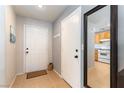 Bright entryway with tile flooring, coat hooks, and a glimpse into the kitchen at 10254 Martinsburg Ct, Las Vegas, NV 89183