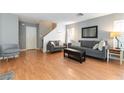 Comfortable living room with modern furniture, wood floors, and neutral decor at 10254 Martinsburg Ct, Las Vegas, NV 89183