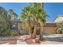 Charming single-story home boasting a well-manicured yard, desert landscaping, and an attached two-car garage at 10310 Songsparrow Ct, Las Vegas, NV 89135