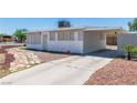 Charming single-story home with a gravel yard, carport, and a mix of stone and wood siding at 1121 W Monroe Ave, Las Vegas, NV 89106