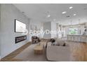 Open-concept living room showcasing a fireplace, modern décor, and seamless flow into the kitchen area at 1506 Camino Summit Ave, Henderson, NV 89012