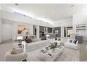 Spacious open-concept living room featuring modern decor, recessed lighting, and views into the open kitchen at 1596 Pleasant Bay Ct, Henderson, NV 89011
