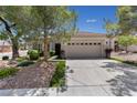 Inviting single-story home showcasing a large driveway and desert landscaping at 2029 Poppywood Ave, Henderson, NV 89012