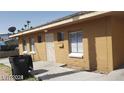 Single-story building shows simple structure, functional windows, and a security door at 2417 St George St, North Las Vegas, NV 89030