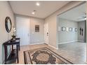 Welcoming entryway with neutral tones, a decorative rug, and views into the adjacent living space at 262 Inflection St, Henderson, NV 89011