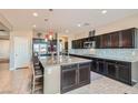 Spacious kitchen featuring a large island with seating, stainless steel appliances, and ample cabinet space at 262 Inflection St, Henderson, NV 89011